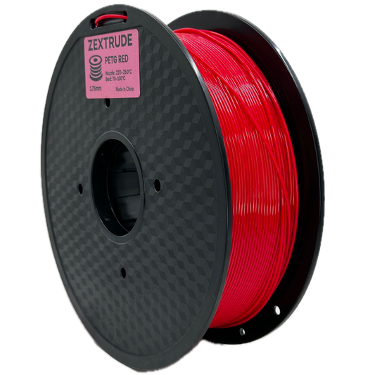 Spool of red 3D printing filament on a black spool with Zortrax branding.
